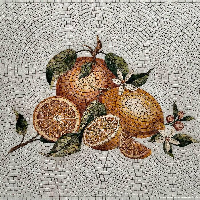 A brilliant and beautiful mosaic art piece depicting oranges with leaves and blossoms, crafted with intricate designs.