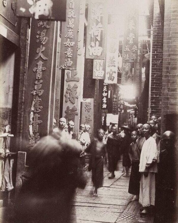 Historical Moments: Busy street scene with Chinese characters on banners, Asia, circa 1880. Lost to History Moment.