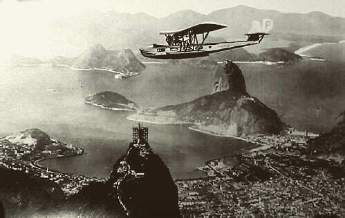A vintage plane flying over Rio de Janeiro, Brazil, showcasing a moment nearly lost to history.