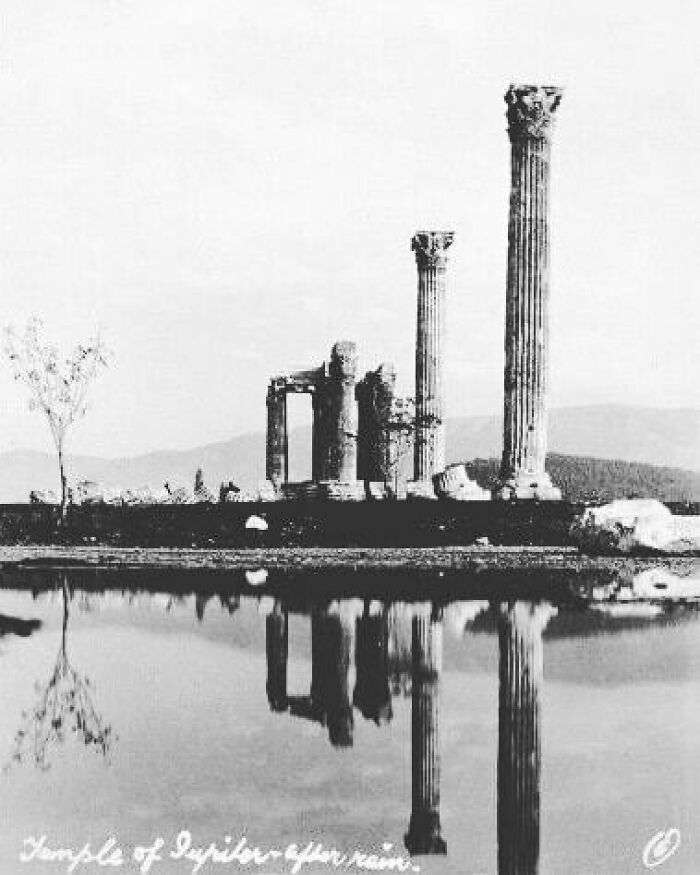 Ancient ruins reflected in water, moments lost to history captured in a photograph.