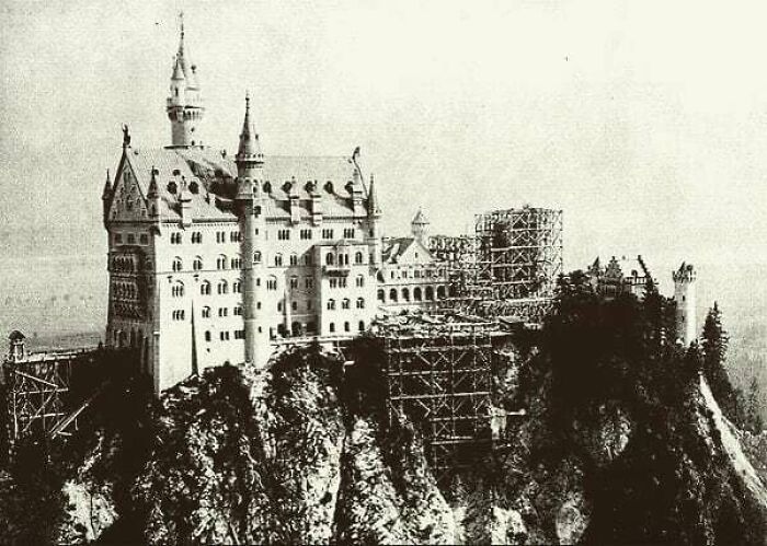 A sepia-toned image of the Neuschwanstein Castle under construction, a moment nearly lost to history.