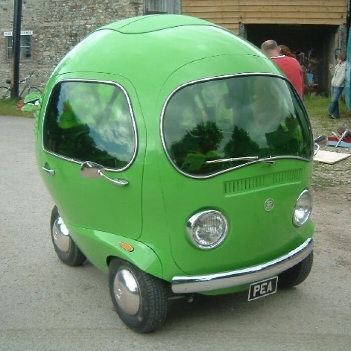A bright green, pea-shaped car with the license plate PEA, a weird and unexpected moment that brightens the day.