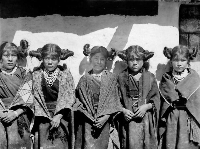 Five Indigenous women with traditional hairstyles and attire, representing moments nearly lost to history.