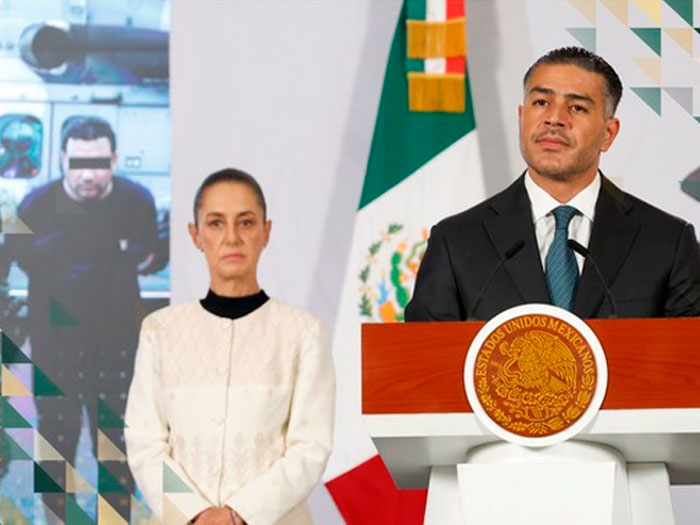 Two government officials at a press conference, with a blurred image of an arrested cartel boss in the background. Two government officials at a press conference, with a blurred image of an arrested cartel boss in the background.