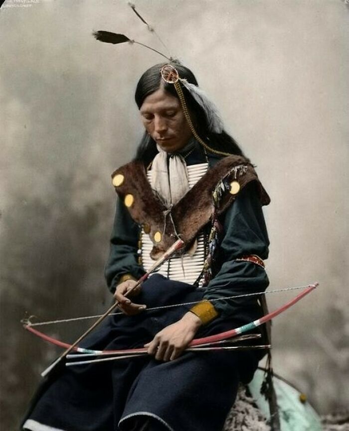 A Native American man with a bow and arrows, a moment nearly lost to history.