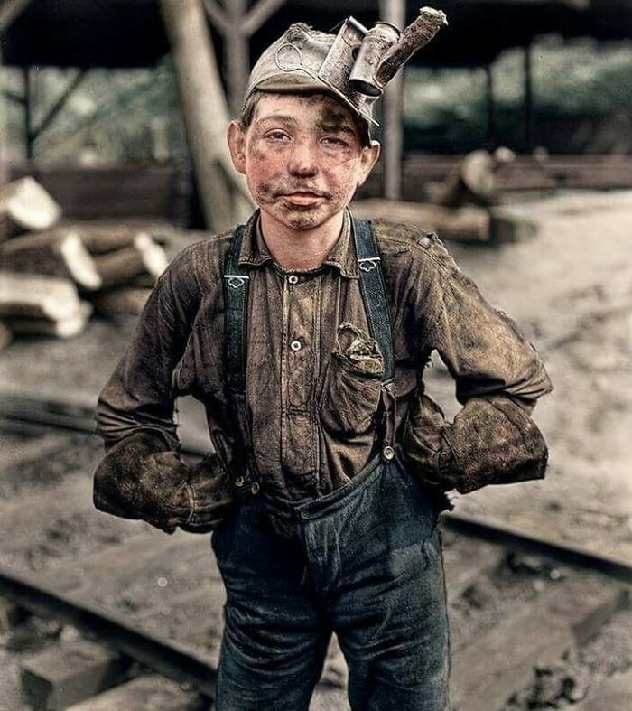 Young coal miner with a headlamp and dirty face, a moment nearly lost to history.