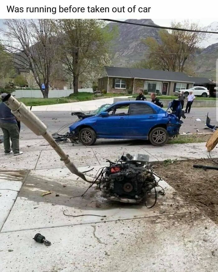 Funny meme of a blue car after a serious accident, with its engine and exhaust system detached and laying on the ground, illustrating overcoming car challenges.