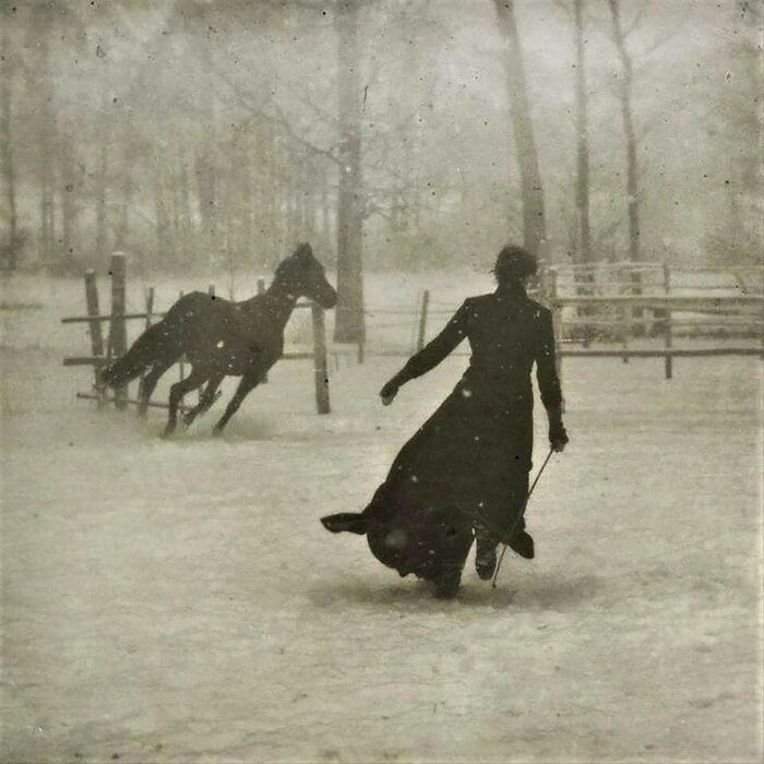 A silhouetted woman in a long dress running after a horse in a snowy, wooded area, a moment nearly lost to history.