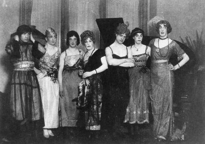 A group of seven people in period attire, one of the moments nearly lost to history.