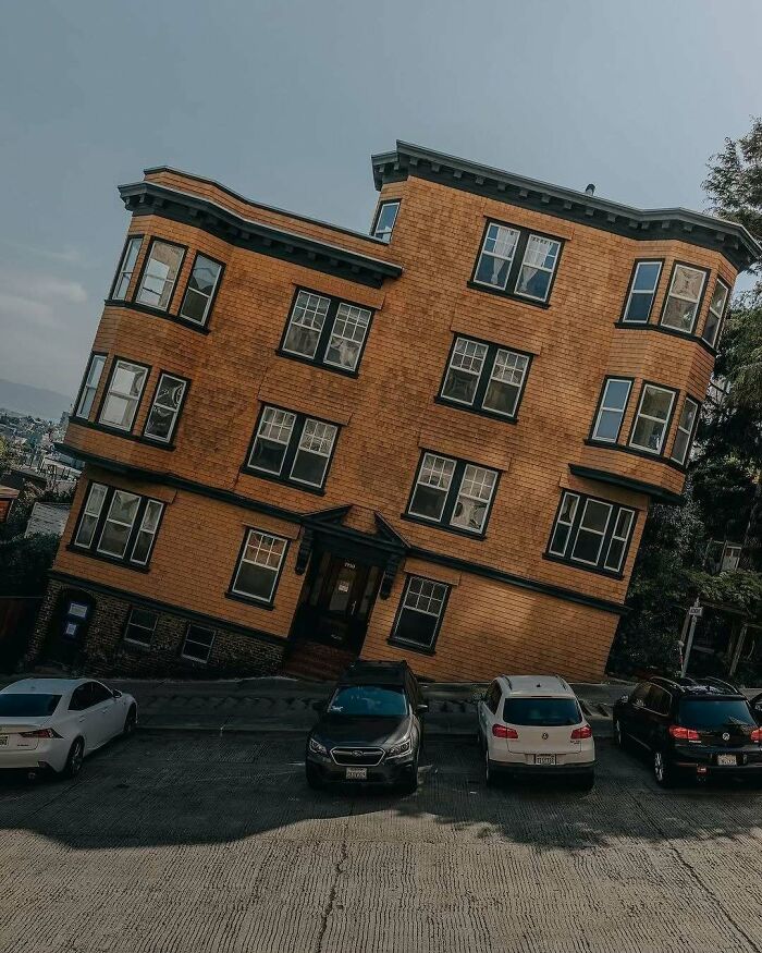 Brilliant design: a building on a very steep hill, appearing crooked due to the unusual angle, a brilliant and beautiful design.
