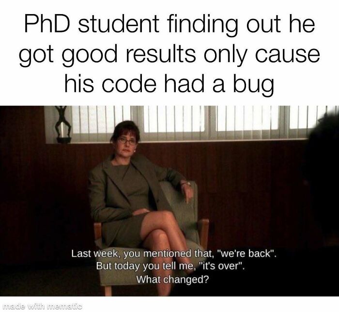 A woman in a suit, from a movie scene, represents a PhD student learning about a code bug. A relatable PhD meme.