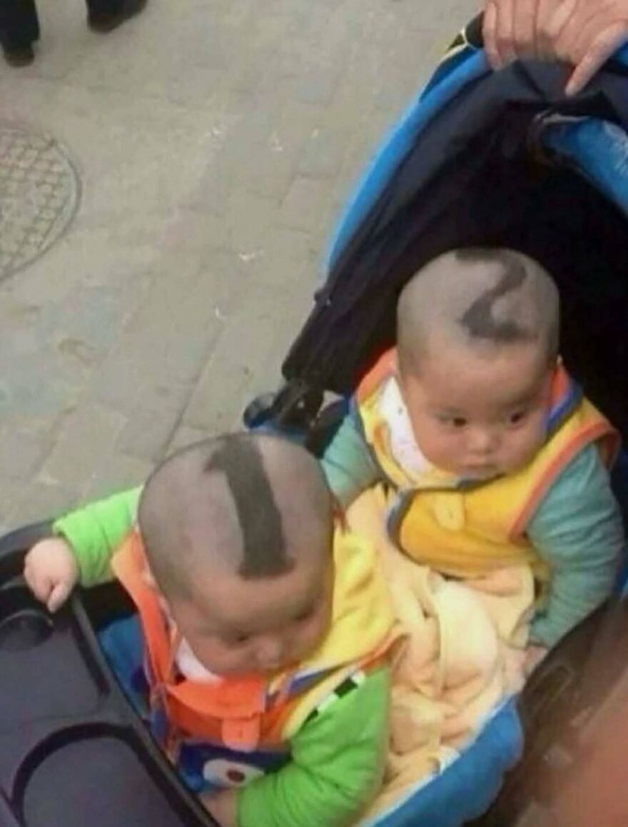 Two babies with numbers shaved into their hair in a stroller, one of many random and unhinged images.