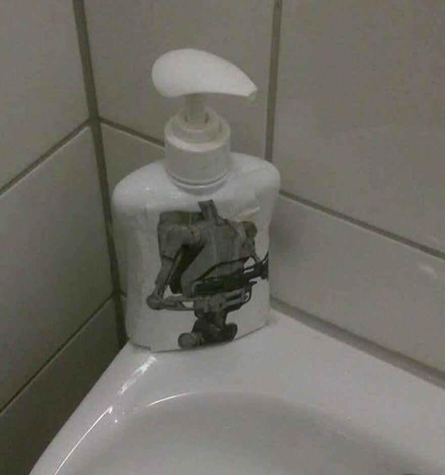 A soap dispenser with a bizarre, unhinged image of a robot on it, a truly random object.