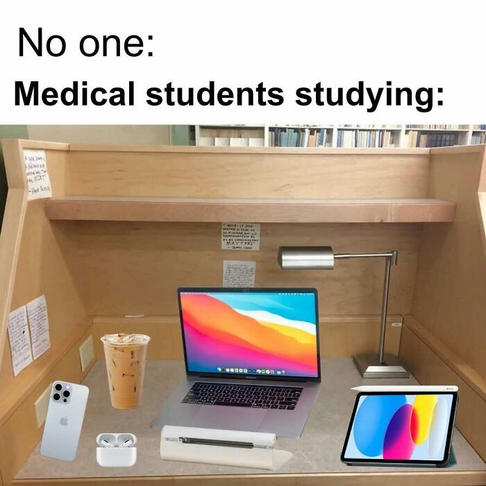 A funny medical meme showing a highly organized study desk of a medical student, with a laptop, tablet, and coffee.