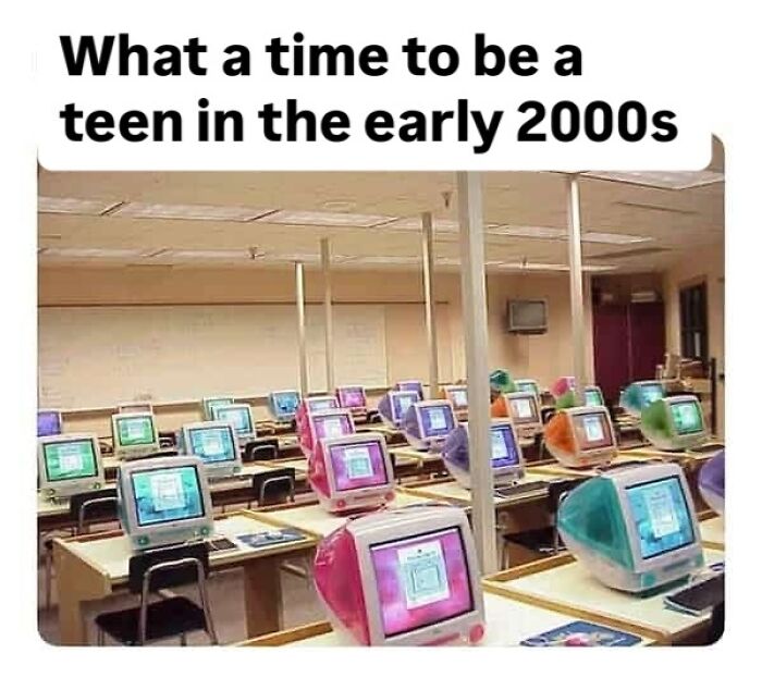 A classroom full of colorful iMac G3 computers from the early 2000s, evoking pure nostalgia for Saturday mornings.