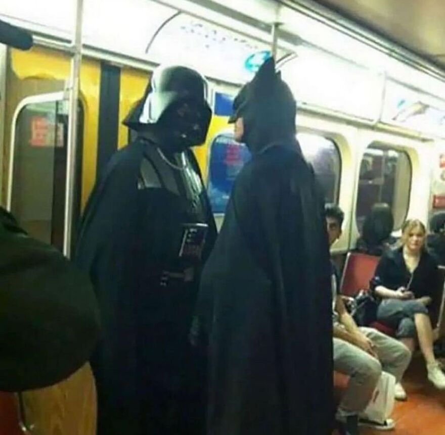 A cursed image of Darth Vader and Batman facing each other on a subway train, creating a random scene.