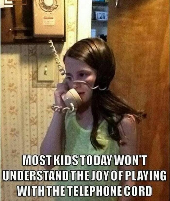 A young girl in a green top wraps a telephone cord around her arm, a pure nostalgia gem.