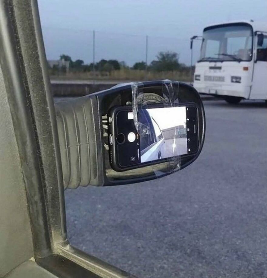 A phone taped to a car mirror, an unhinged image that is truly cursed.