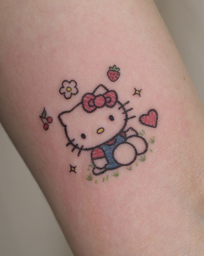 Cute Hello Kitty tattoo resembling a childhood crayon drawing, highlighting artistic and unfiltered creativity.