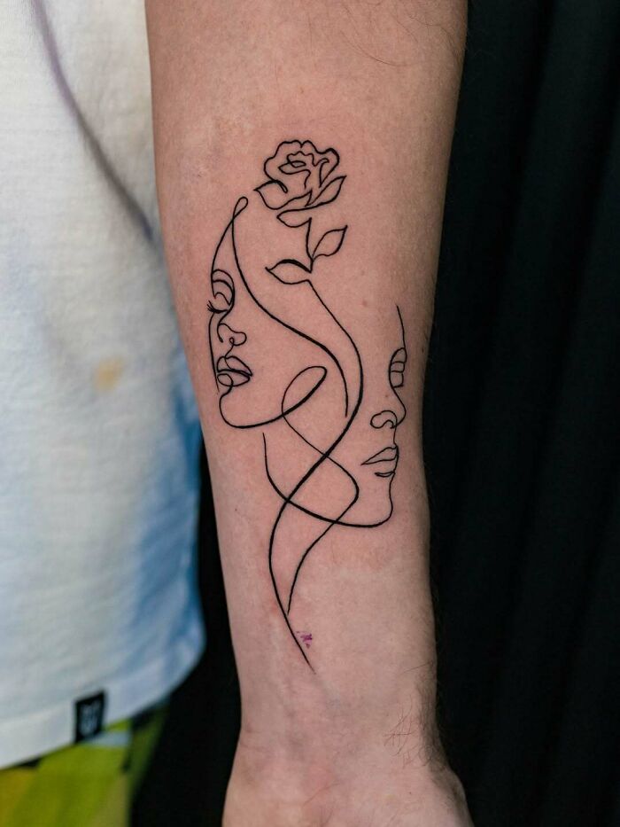 Minimalist linework tattoo ideas for women, featuring two faces and a rose on the forearm.