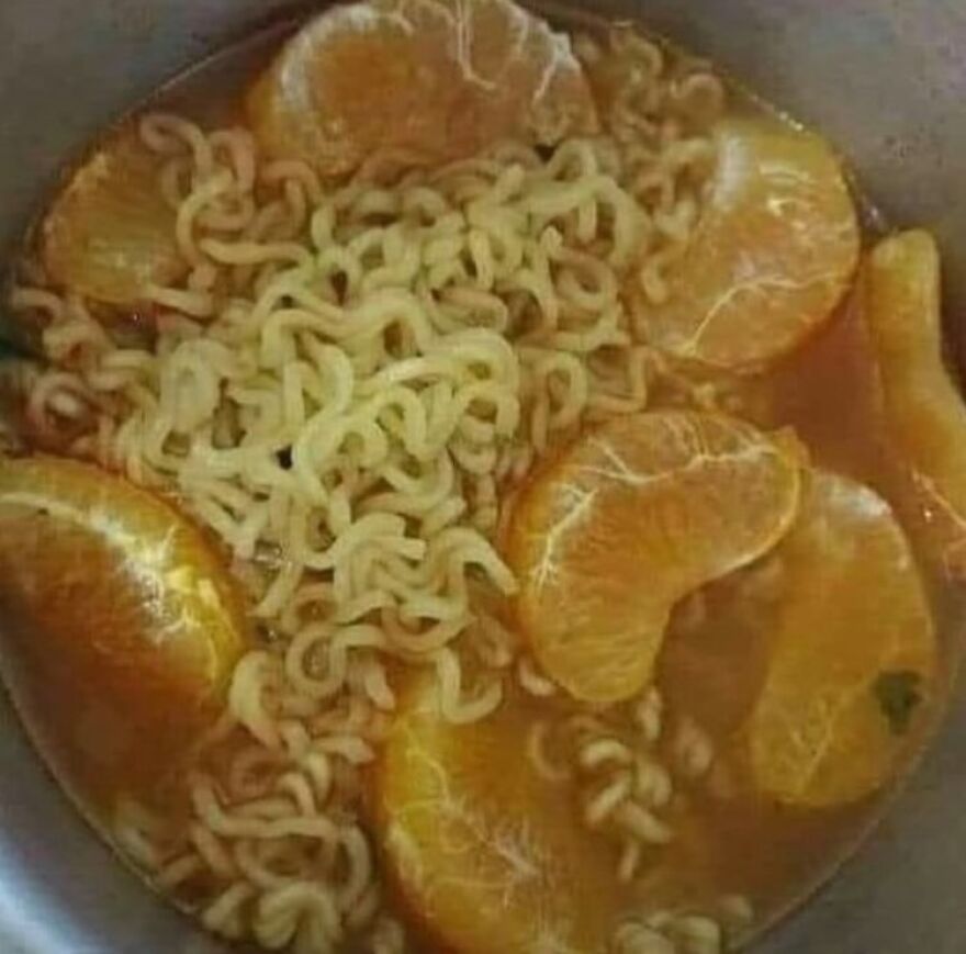Ramen noodles with orange slices in a bowl, an unhinged and cursed image.