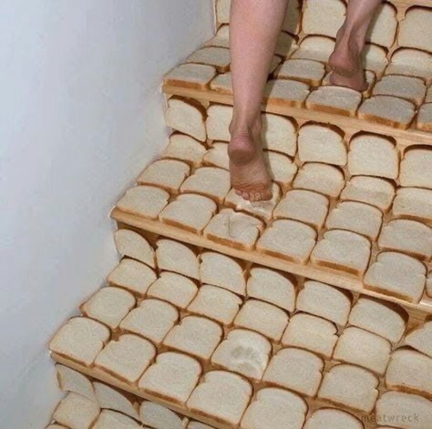 Bare feet walk up stairs covered in slices of white bread, creating a cursed, unhinged image.