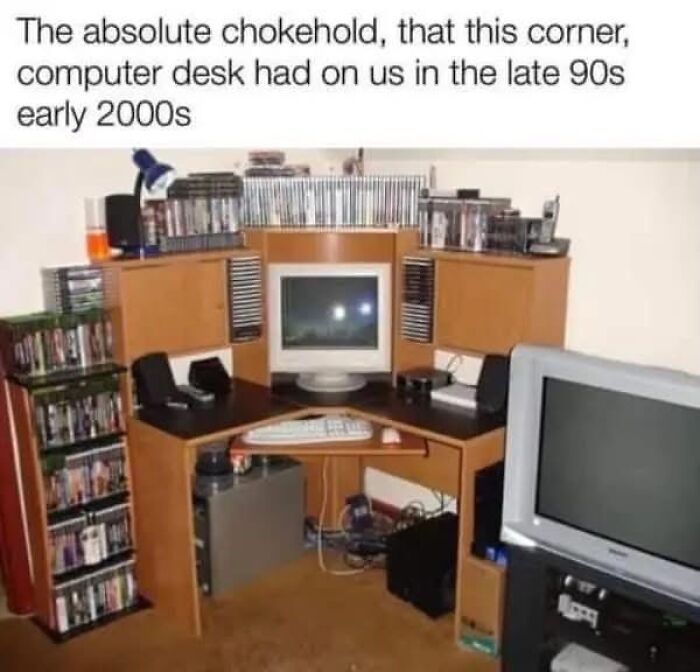 A corner computer desk from the late 90s/early 2000s, surrounded by CDs and a CRT monitor, a true nostalgia gem.