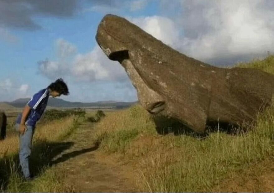 A person bowing to a fallen moai statue on a grassy hill, among other unhinged images.