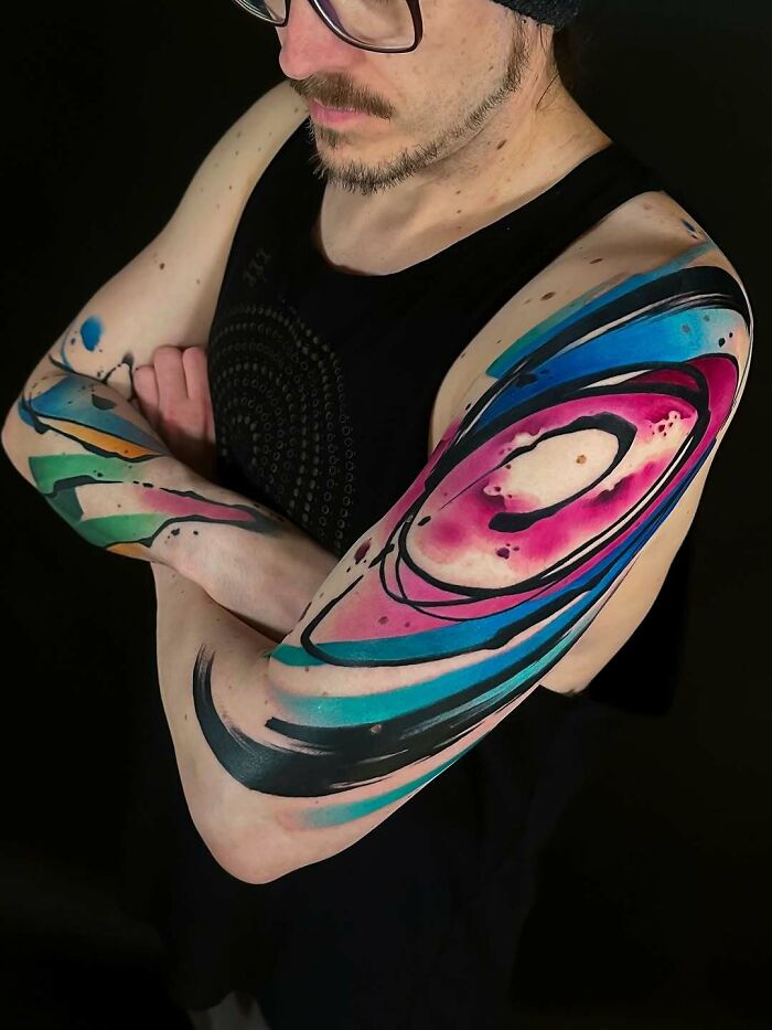 Colorful abstract tattoo ideas for women, a vibrant and unique sleeve design.