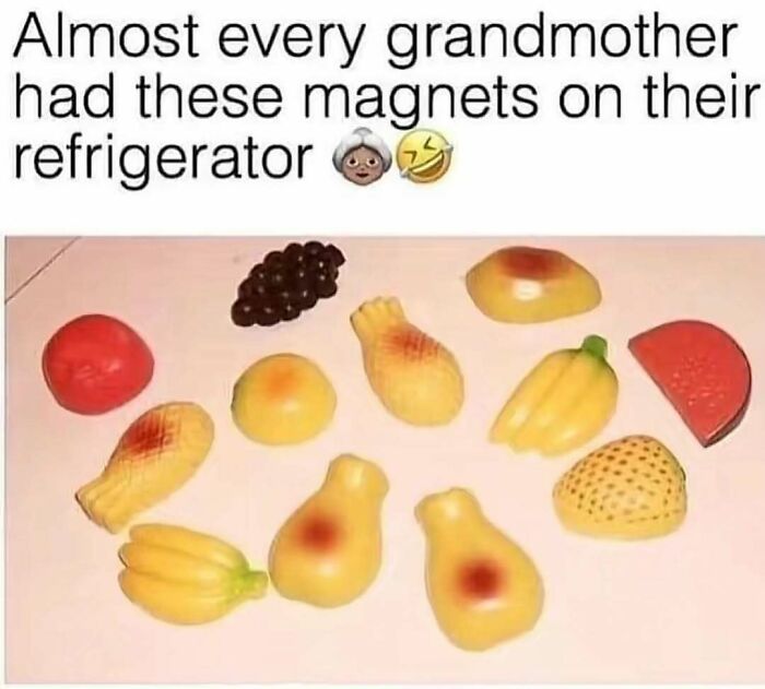 A collection of fruit-shaped refrigerator magnets, including grapes, bananas, and a watermelon slice. These pure nostalgia gems were common in grandmothers' homes.