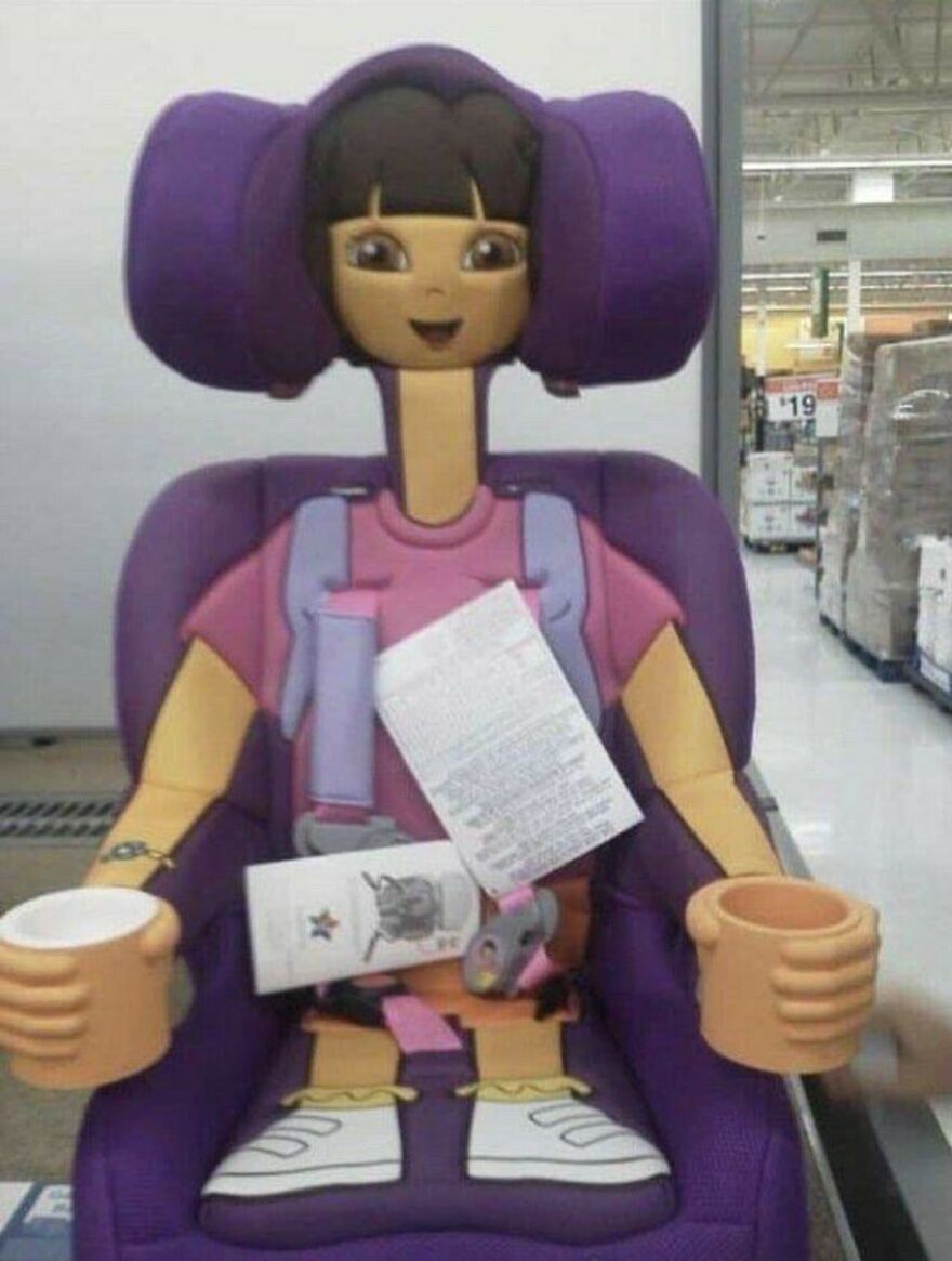 A Dora the Explorer themed car seat, looking unsettlingly like a stuffed doll, one of the cursed images.