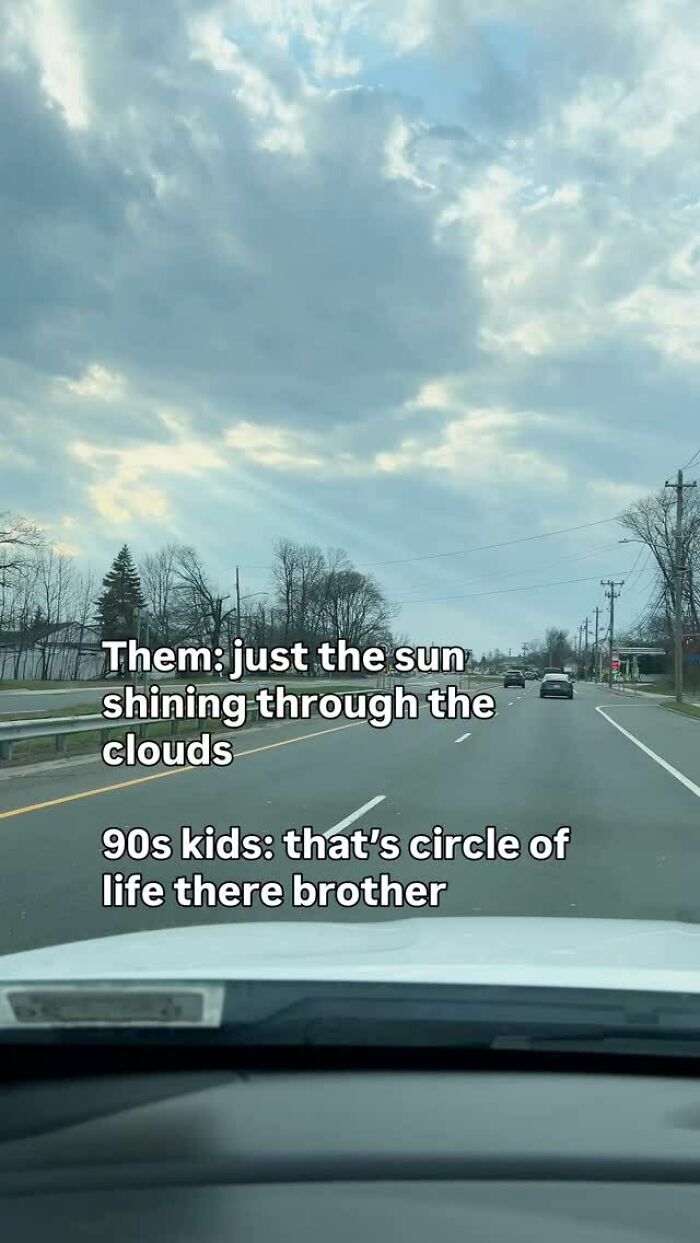 A car interior view of a road with trees, showing a cloudy sky. A caption compares how 90s kids see the sun shining through clouds to the circle of life. Pure nostalgia gems.