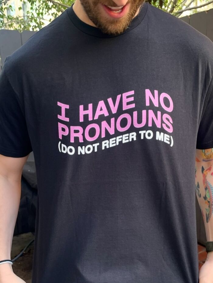 Iconic shirts, a black T-shirt with the phrase 'I have no pronouns (do not refer to me)' in pink.