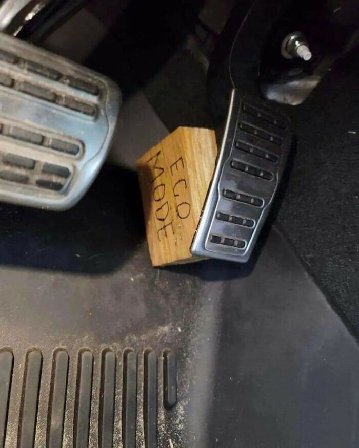 Funny car meme showing a wooden block labeled ECO MODE wedged under a car accelerator pedal.