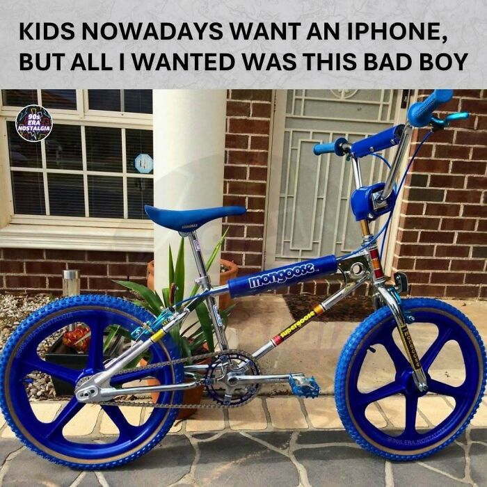 A vintage Mongoose BMX bike with blue mag wheels and chrome frame parked outside, evoking 90s memes nostalgia for children's bikes.