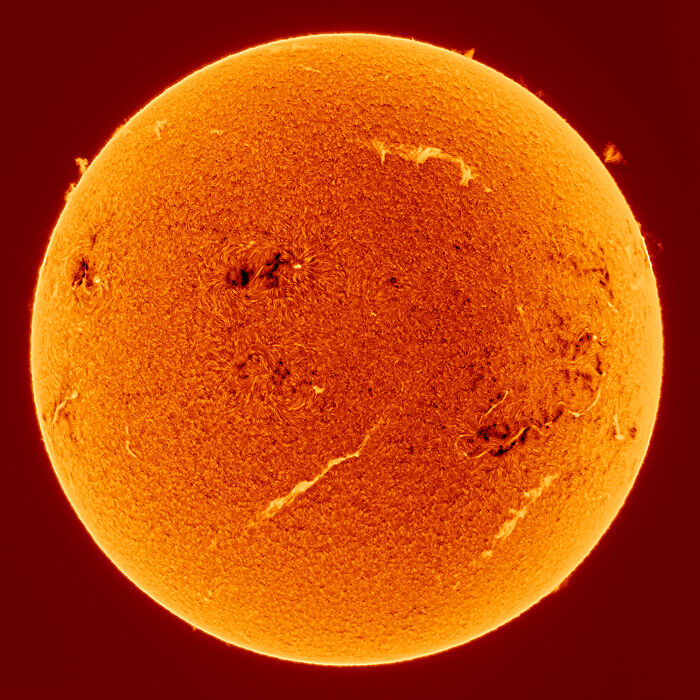 A detailed view of the sun showing its textured, fiery surface.