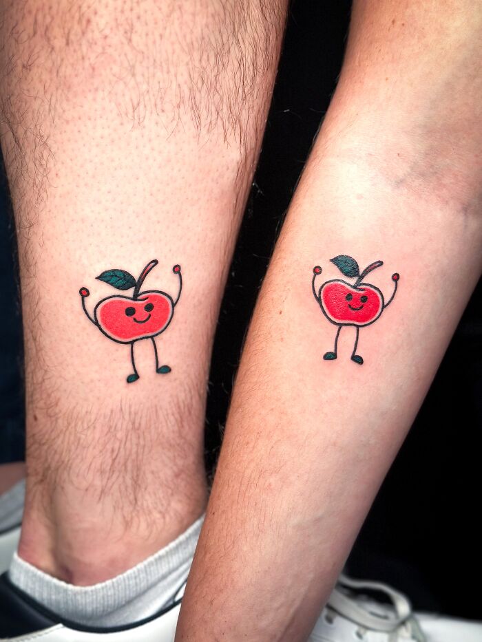 Matching ink ideas: two people with adorable matching apple tattoos on their legs.