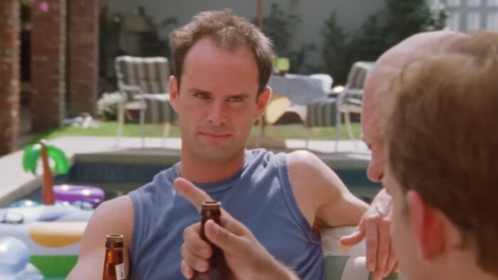 TV star Walton Goggins by a pool, experiencing fan backlash for his bizarre 84-episode flex.