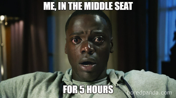 A travel meme featuring a man with tears in his eyes, representing the discomfort of being in a middle seat during a flight.