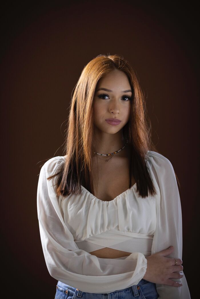 Portrait of a beautiful natural redhead woman with long, straight red hair, celebrating redheads.