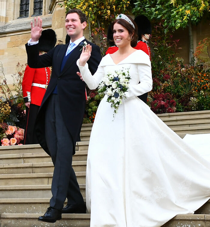 Princess Eugenie and Jack Brooksbank waving at their wedding, connecting to Meghan Markle's Karma. Princess Eugenie and Jack Brooksbank waving at their wedding, connecting to Meghan Markle's Karma.