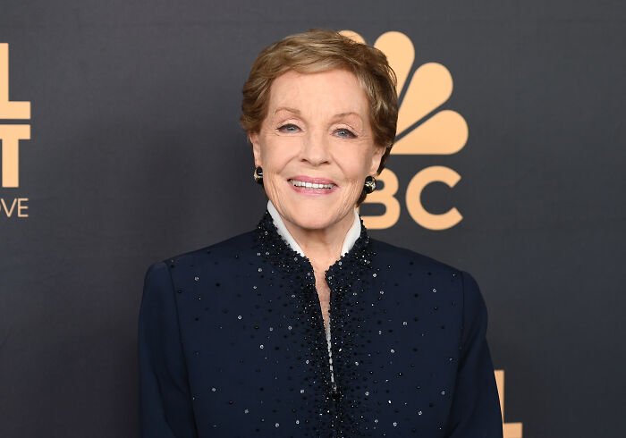 Legendary actress Julie Andrews smiles in a dark, embellished jacket. Legendary actress Julie Andrews smiles in a dark, embellished jacket.