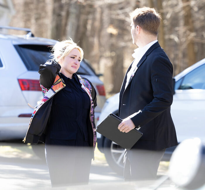 Hayden Panettiere looking distressed, standing outdoors with a man. Her childhood history resurfaces after her sudden passing.