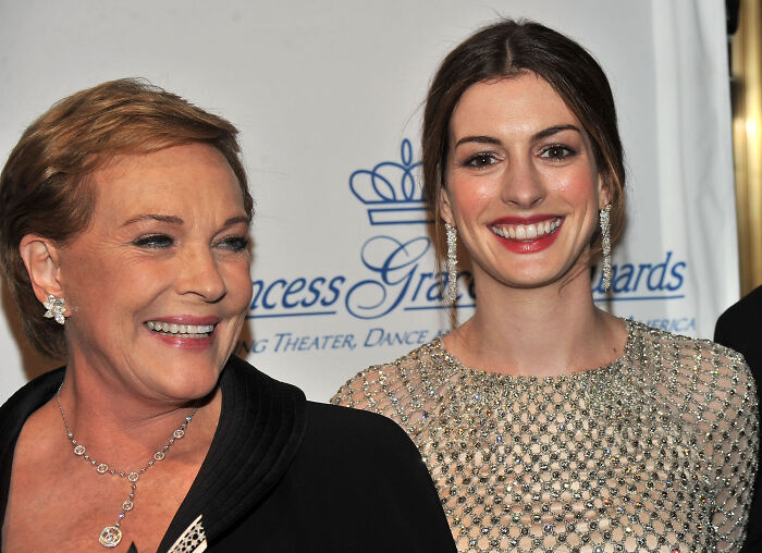 Anne Hathaway and Julie Andrews smiling together at an event. Anne Hathaway and Julie Andrews smiling together at an event.
