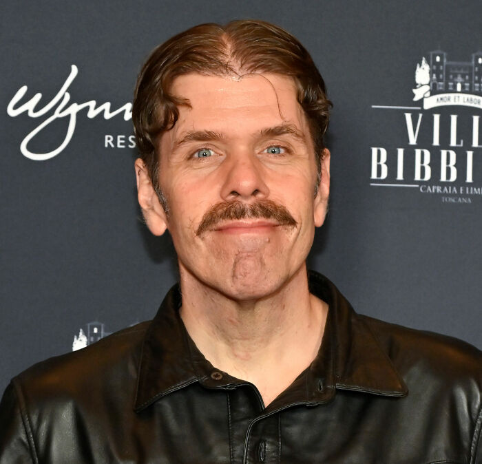 Perez Hilton with a mustache, looking at the camera from his hospital bed after a horrifying livestream. Perez Hilton with a mustache, looking at the camera from his hospital bed after a horrifying livestream.