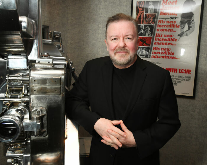 Ricky Gervais, 65, posing next to a film projector, revealing why he plans to marry partner of 44 years. Ricky Gervais, 65, posing next to a film projector, revealing why he plans to marry partner of 44 years.