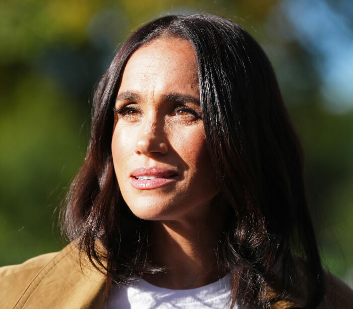 Meghan Markle with long dark hair, looking thoughtful. A birthday post detail. Meghan Markle with long dark hair, looking thoughtful. A birthday post detail.
