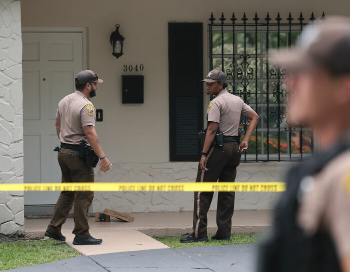 Police officers at a crime scene, investigating the context of Perez Hilton's horrifying livestream and hospital bed. Police officers at a crime scene, investigating the context of Perez Hilton's horrifying livestream and hospital bed.