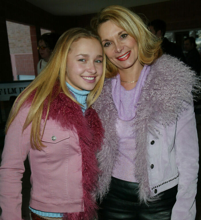 Young Hayden Panettiere smiling with her mother, both in purple and pink furry jackets. Young Hayden Panettiere smiling with her mother, both in purple and pink furry jackets.