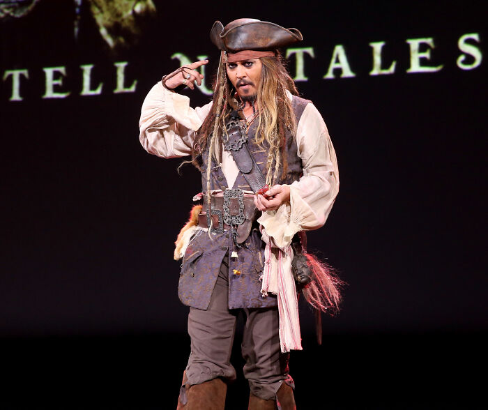Johnny Depp dressed as Captain Jack Sparrow on stage, embodying his role in a blockbuster franchise. Johnny Depp dressed as Captain Jack Sparrow on stage, embodying his role in a blockbuster franchise.